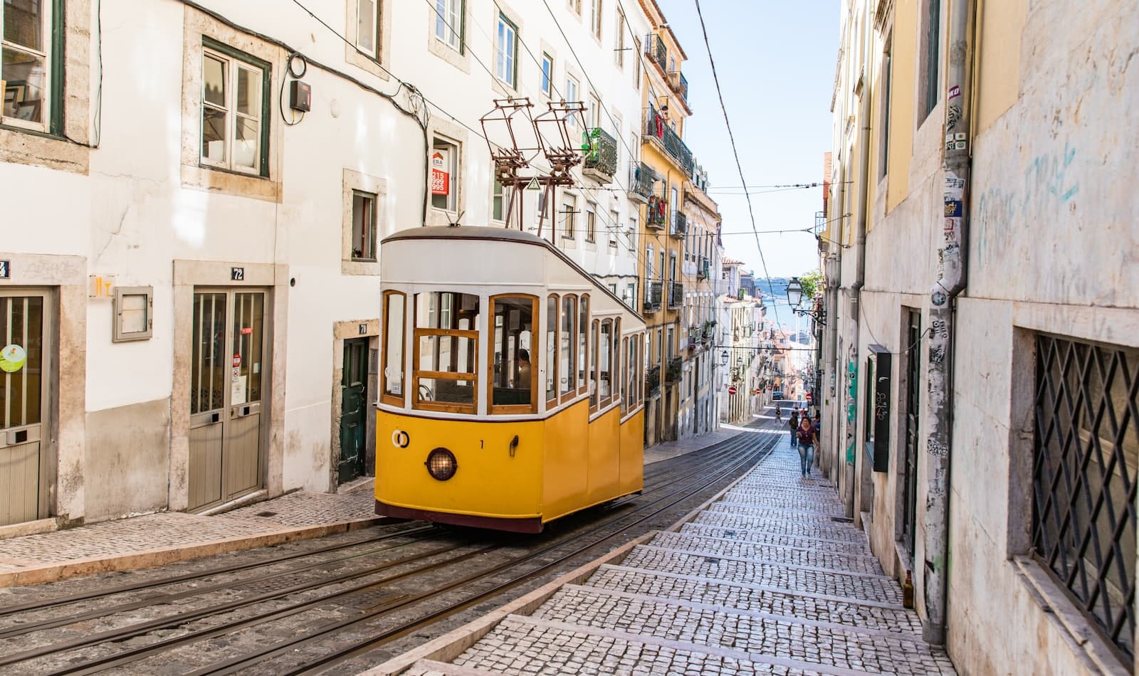 a yellow tram climbing Bica, Lisbon